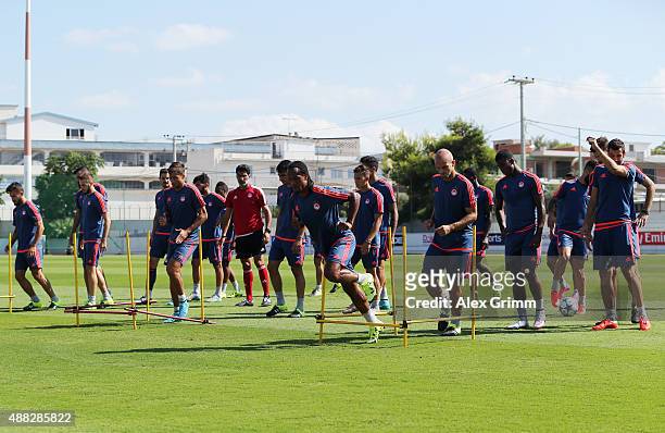 Players attend a Olympiacos FC training session ahead of their UEFA Champions League Group F match against Bayern Muenchen at Olympiacos training...