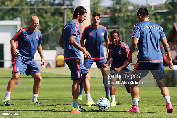 Esteban Cambiasso, Alejandro Dominguez, Leandro Salino and team mates exercise during a Olympiacos FC training session ahead of their UEFA Champions...