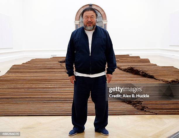 Ai Weiwei stands with his sculpture 'Straight' as he previews works from His landmark art exhibition on September 15, 2015 in London, England. The...