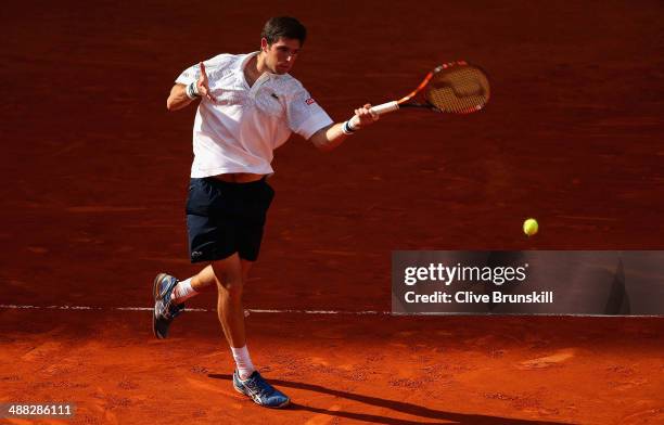 Federico Delbonis of Argentina plays a forehand against Feliciano Lopez of Spain in their first round match during day three of the Mutua Madrid Open...