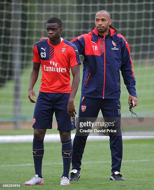 Stephy Mavididi of Arsenal and Thierry Henry assisting with the coaching session during the U19 training session at London Colney on September 15,...