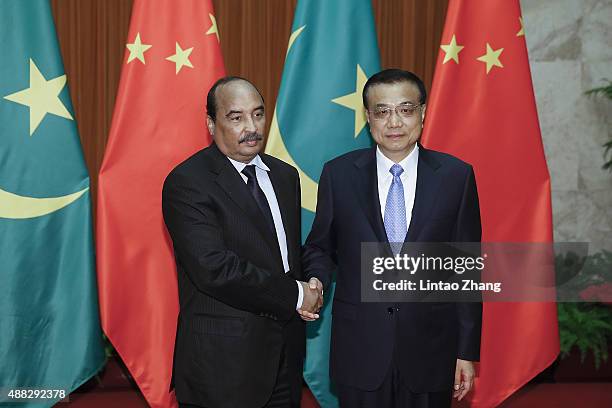 Mauritania's President Mohamed Ould Abdel Aziz shakes hands with Chinese Premier Li Keqiang at the Great Hall of the People on September 15, 2015 in...