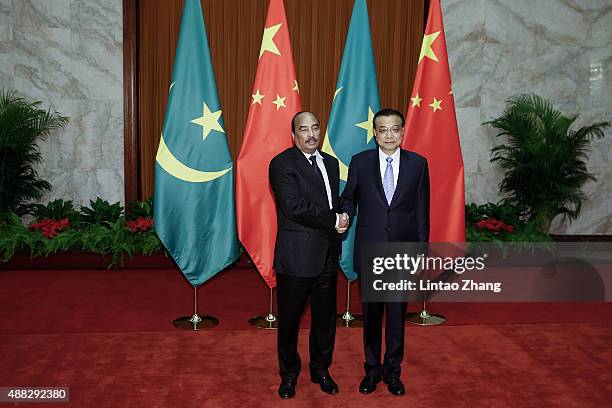 Mauritania's President Mohamed Ould Abdel Aziz shakes hands with Chinese Premier Li Keqiang at the Great Hall of the People on September 15, 2015 in...