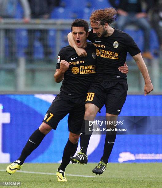 Marquinho with his teammate Marco Donadel of Hellas Verona celebrates after scoring the first team's goal during the Serie A match between SS Lazio...