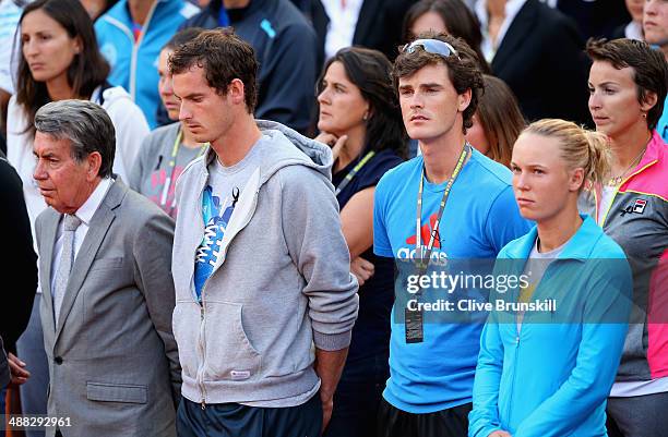 Tournament director Manolo Santana, Andy Murray and Jamie Murray of Great Britain and Caroline Wozniacki of Denmark stand for a minutes silence for...