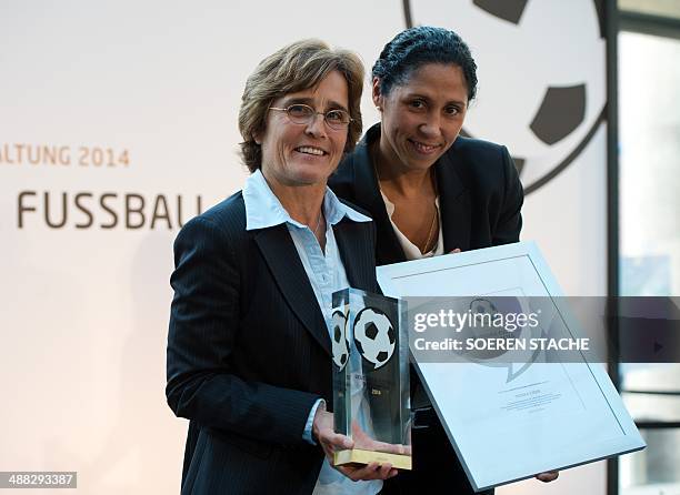 Former German football player Steffi Jones , and German coach Monika Staab titled the "Football Ambassador 2014" pose on May 5, 2014 in the atrium of...