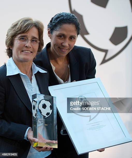 Former German football player Steffi Jones , and German coach Monika Staab titled the "Football Ambassador 2014" pose on May 5, 2014 in the atrium of...