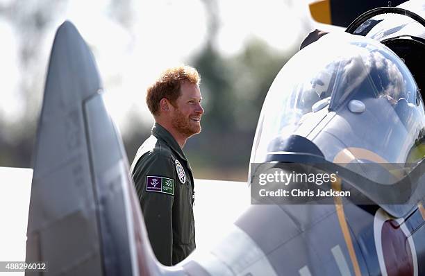 Prince Harry chats to Spitfire pilots as they take off on the airfield at Goodwood Aerodrome during a Battle of Britain Flypast at Goodwood on...