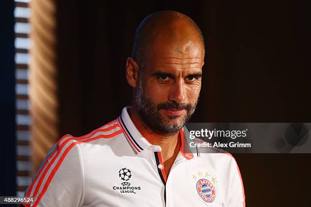 Head coach Pep Guardiola arrives for a Bayern Muenchen press conference ahead of their UEFA Champions League Group F match against Olympiacos FC at...