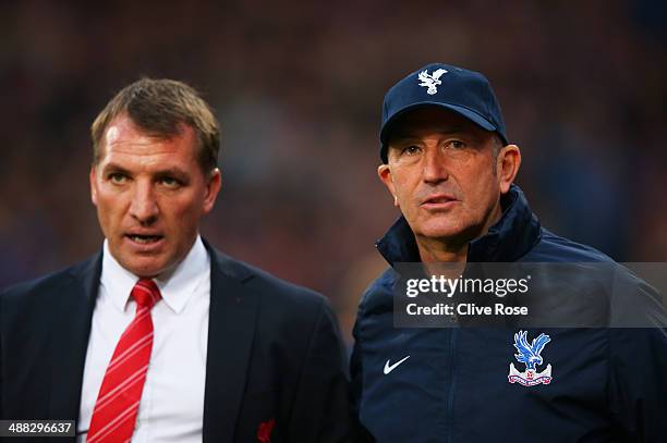 Brendan Rogers the Liverpool manager speaks with Tony Pulis the Crystal Palace manager prior to kickoff during the Barclays Premier League match...