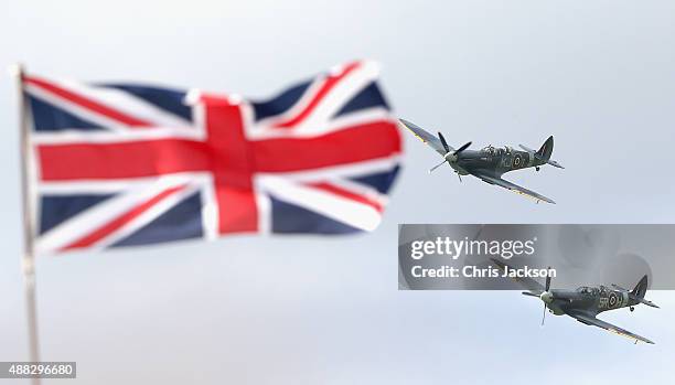 Vintage planes fly in formation as part of a Battle of Britain 75th Anniversary flypast at Goodwood Aerodrome at Goodwood on September 15, 2015 in...