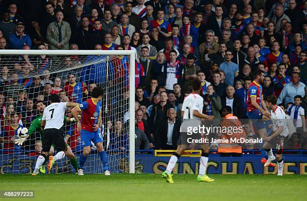 Goalkeeper Julian Speroni of Crystal Palace dives in vain as Joe Allen of Liverpool scores the opening goal during the Barclays Premier League match...