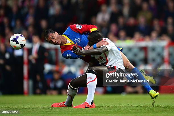 Marouane Chamakh of Crystal Palace wins a header under pressure from Mamadou Sakho of Liverpool during the Barclays Premier League match between...