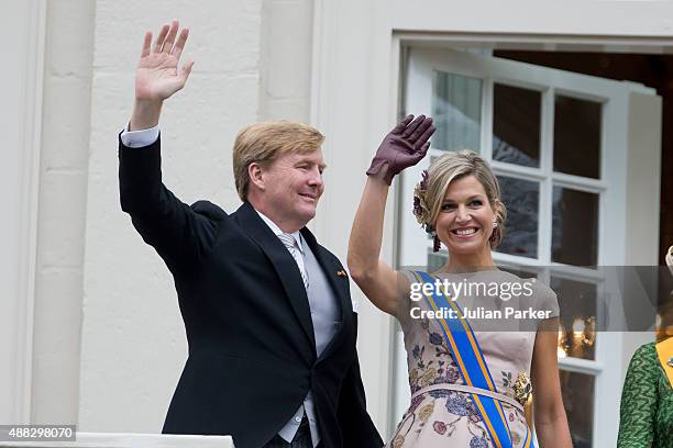 King Willem-Alexander and Queen Maxima of The Netherlands wave from the balcony of The Noordeinde Palace during Prinsjesdag on September 15, 2015 in...