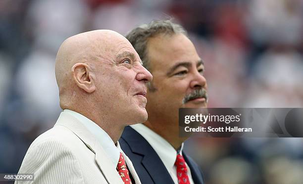 Houston Texans owner Robert McNair waits on the field with his son Cal before their game against the Kansas City Chiefs at NRG Stadium on September...