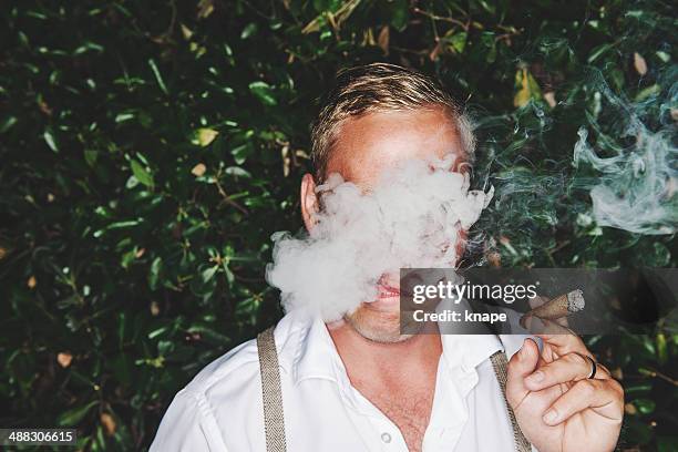 man smoking cigar - cigar stock pictures, royalty-free photos & images