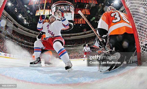 Martin St. Louis of the New York Rangers skates in the crease of Steve Mason of the Philadelphia Flyers in Game Six of the First Round of the 2014...