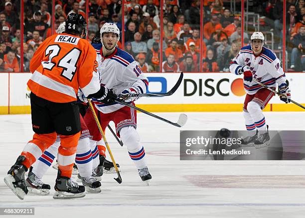 Derick Brassard of the New York Rangers shoots the puck against Matt Read of the Philadelphia Flyers in Game Six of the First Round of the 2014...