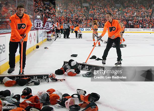 Members of the Philadelphia Flyers Ice Crew clean the hats off the ice following Wayne Simmonds of the Philadelphia Flyers hat trick against the New...