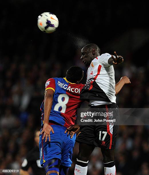 Mamadou Sakho of Liverpool competes with Kagisho Dikgacoi of Crystal Palace during the Barclays Premier Leuage match between Crystal Palace and...