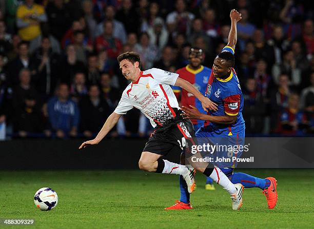 Joe Allen of Liverpool competes with Kagisho Dikgacoi of Crystal Palace during the Barclays Premier Leuage match between Crystal Palace and Liverpool...