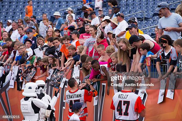 Fans wait for autographs after a game between the Ohio Machine and Denver Outlaws at Sports Authority Field at Mile High on May 4, 2014 in Denver,...