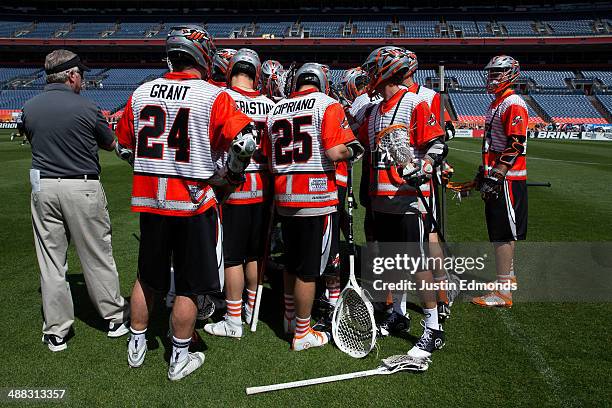 The Denver Outlaws huddle during a game against the Ohio Machine at Sports Authority Field at Mile High on May 4, 2014 in Denver, Colorado. The teams...