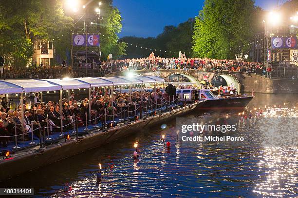 Swimmers carry torches as part of a show for King Willem-Alexander and Queen Maxima of The Netherlands during the Freedom Concert the Freedom Concert...