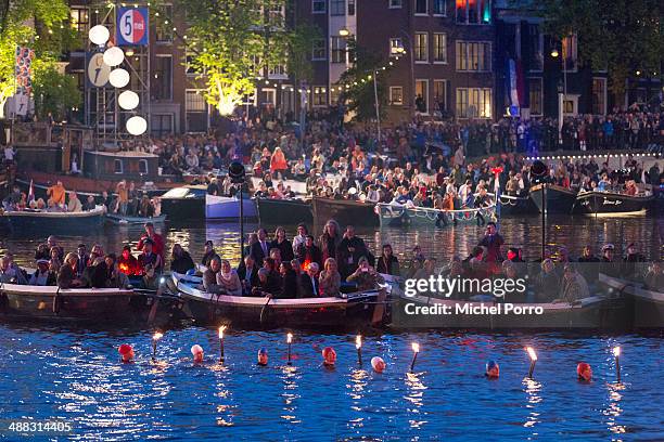 Swimmers carry torches as part of a show for King Willem-Alexander and Queen Maxima of The Netherlands during the Freedom Concert the Freedom Concert...