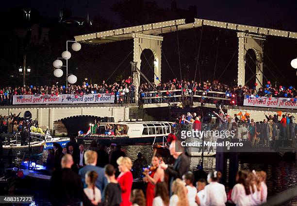 King Willem-Alexander of The Netherlands and Queen Maxima of The Netherlands wave from a boat after the Freedom Concert on May 5, 2014 in Amsterdam,...