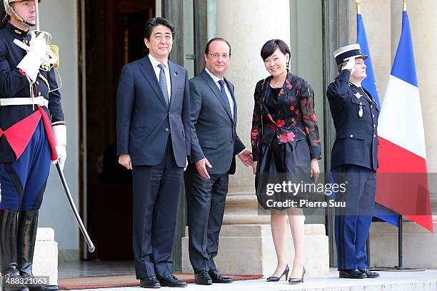 French President Franois Hollande greets Japanese Prime Minister Shinzo Abe and his Wife Akie Abe at the state Dinner At Elysee Palace In Honor Of...