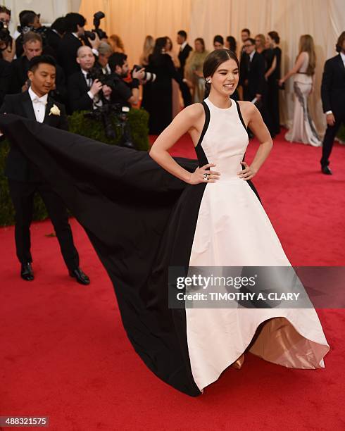 Actress Hailee Steinfeld gets help from designer Prabal Gurung as they arrive at the Costume Institute Benefit at The Metropolitan Museum of Art May...