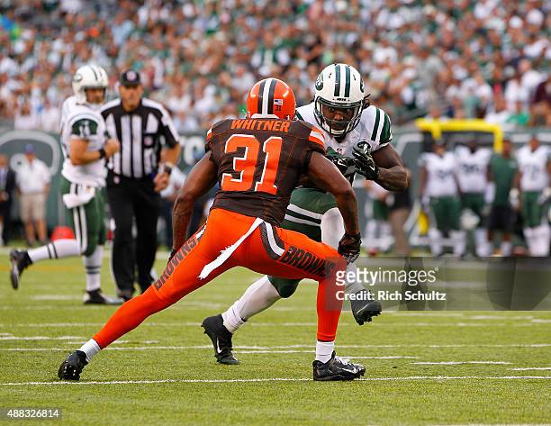 Chris Ivory of the New York Jets looks to get past Donte Whitner the Cleveland Browns during a game at MetLife Stadium on September 13, 2015 in East...