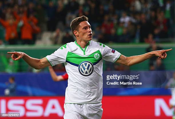 Julian Draxler of VfL Wolfsburg celebrates as he scores their first goal during the UEFA Champions League Group B match between VfL Wolfsburg and PFC...