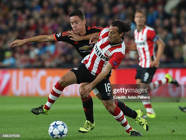 Ander Herrera of Manchester United in action with Andres Guardado of PSV Eindhoven during the UEFA Champions League match between PSV Eindhoven and...