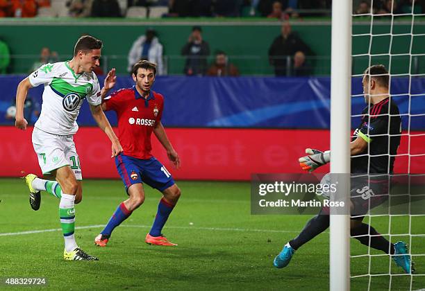 Julian Draxler of VfL Wolfsburg shoots past goalkeeper Igor Akinfeev of CSKA Moscow to score their first goal during the UEFA Champions League Group...