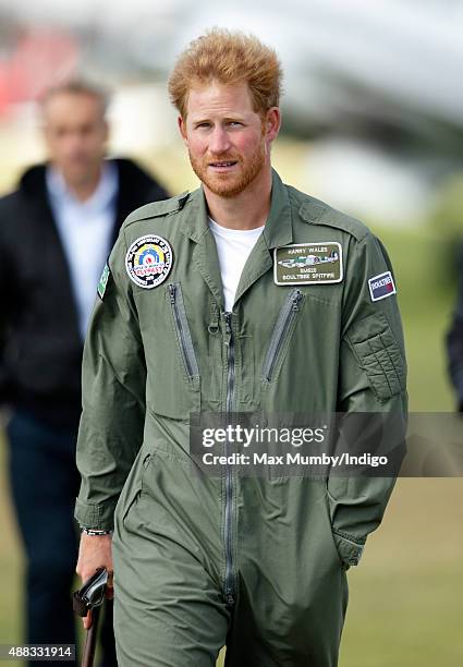 Prince Harry watches Spitfires take off on the airfield at Goodwood Aerodrome during a Battle of Britain Flypast at Goodwood on September 15, 2015 in...