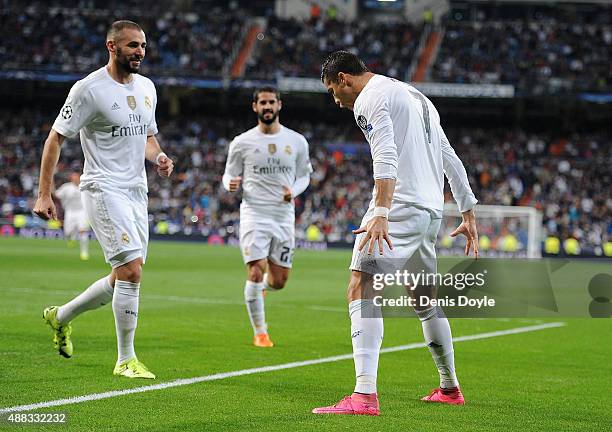 Cristiano Ronaldo of Real Madrid celebrates with Karim Benzema after scoring Real's 2nd goal from the penalty spot during the UEFA Champions League...
