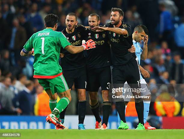 Gianluigi Buffon, Leonardo Bonucci, Giorgio Chiellini and Andrea Barzagli of Juventus celebrate victory as Sergio Aguero of Manchester City look...