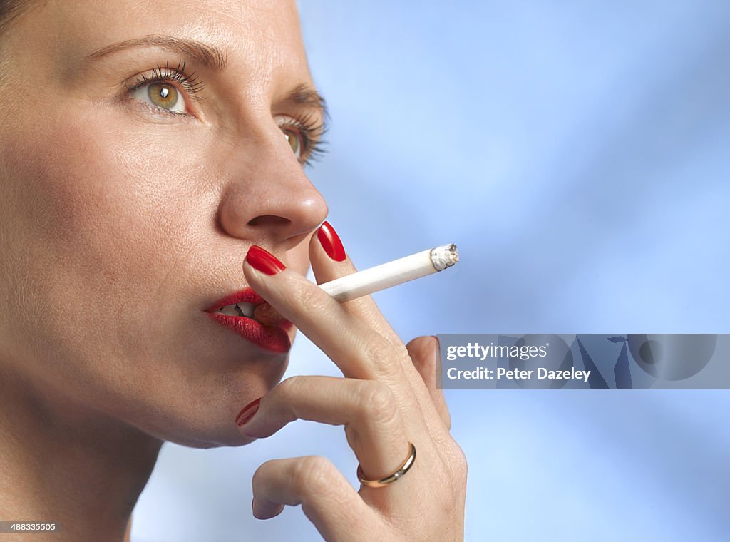 40-year old woman smoking with copy space