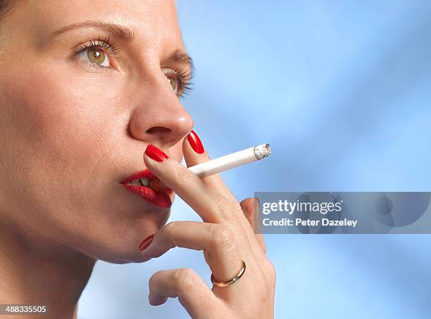 40-year old woman smoking with copy space - woman smoking stock pictures, royalty-free photos & images