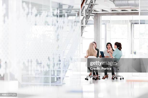 women in business having a meeting in the office - four people talking stock pictures, royalty-free photos & images