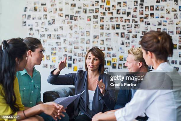 businesswoman leading a casual meeting - authentic photo office bildbanksfoton och bilder