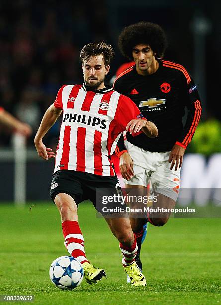 Davy Propper of PSV Eindhoven beats Marouane Fellaini of Manchester United to the ball during the UEFA Champions League Group B match between PSV...