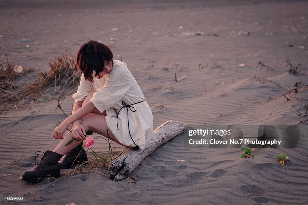 Girl sitting on the beach.