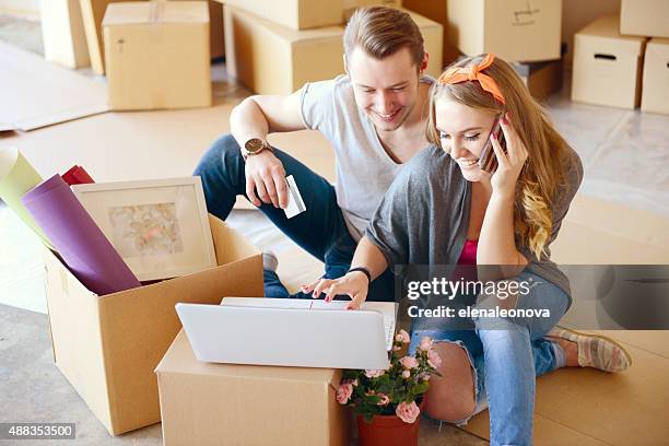 young couple - using laptop and phone stock pictures, royalty-free photos & images