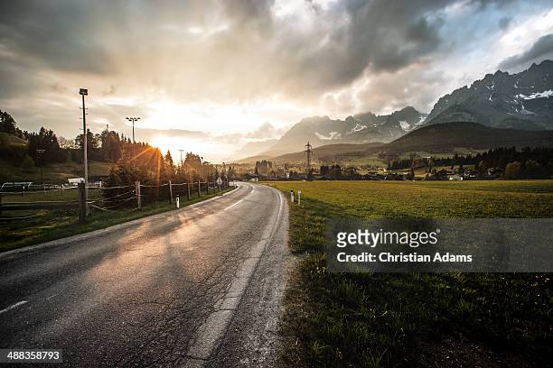 mountain road at sunset - village stock-fotos und bilder