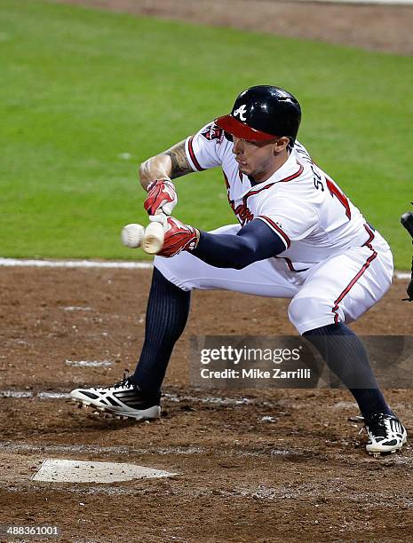 Pinch hitter Jordan Schafer of the Atlanta Braves lays down a bunt during the game against the St. Louis Cardinals at Turner Field on May 5, 2014 in...