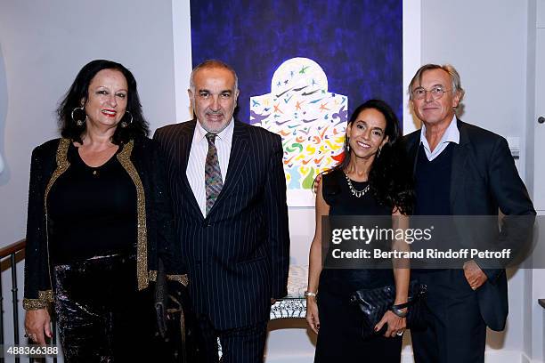 Galerist of Gallery Tindouf, in Marrakech and Tanger, Boubker Temli with his wife, Guest and Pierre Passebon attend the 'Paintings Poems from Tahar...