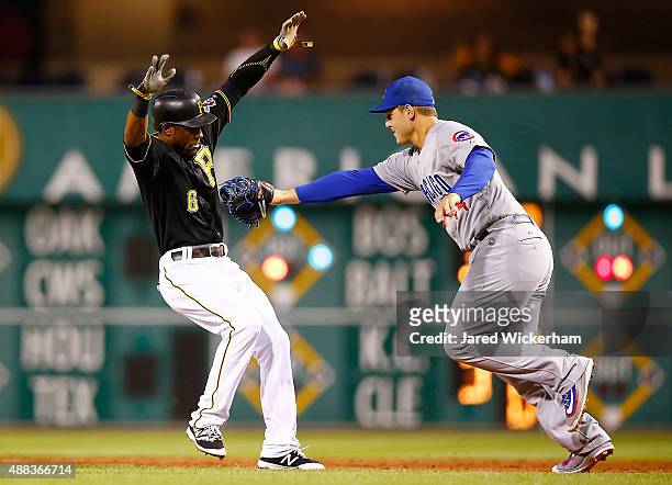 Starling Marte of the Pittsburgh Pirates is tagged out by Anthony Rizzo of the Chicago Cubs after being caught in a rundown at first base in the...